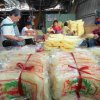 Two sheets of rice noodles are packed into one package. The whole family work together to complete this last process.